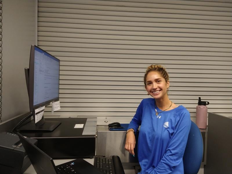 member services student working at their desk