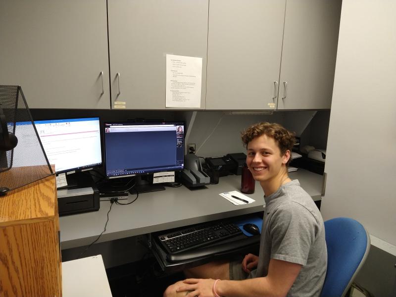 member services student working at their desk