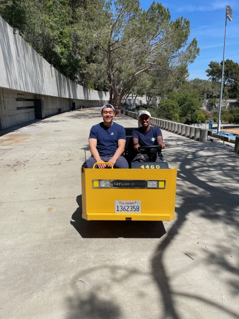 two rec tech students on electric working vehicle