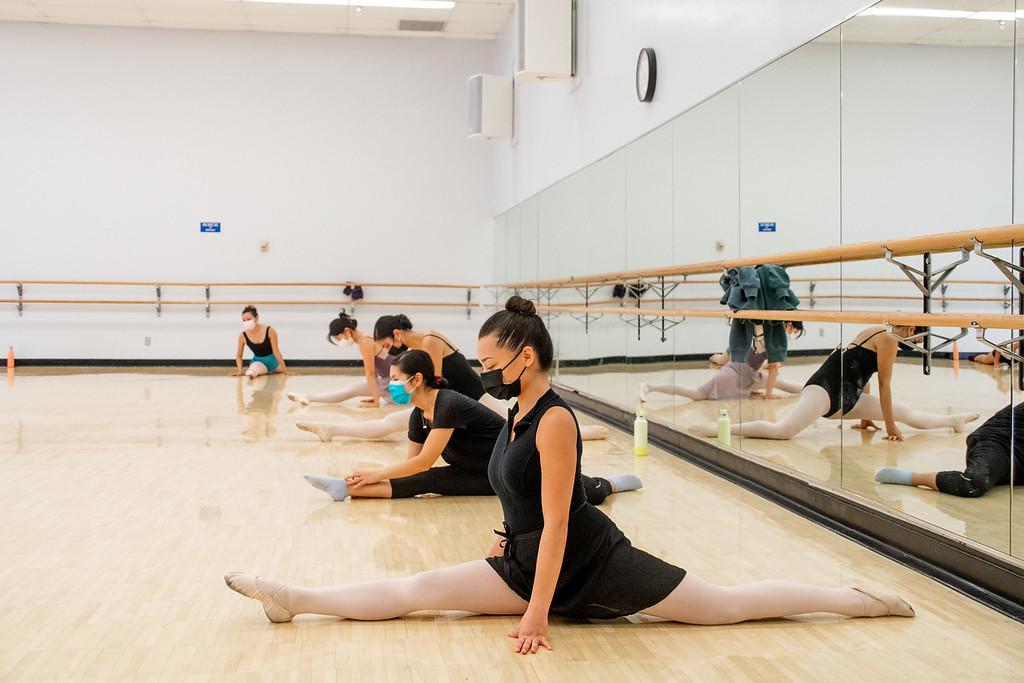 Group of students doing the splits in a ballet class