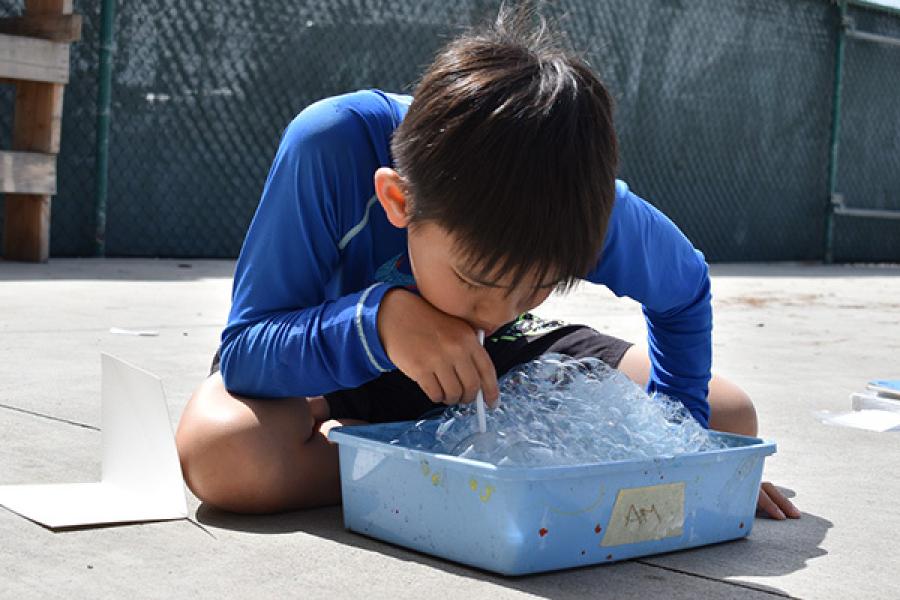 A boy playing with the bubble