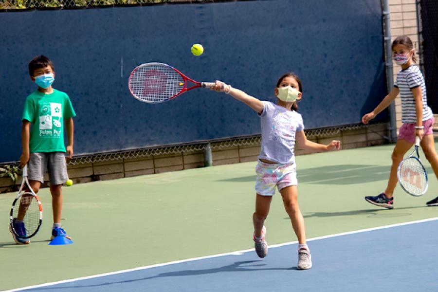 Three Children playing tennis