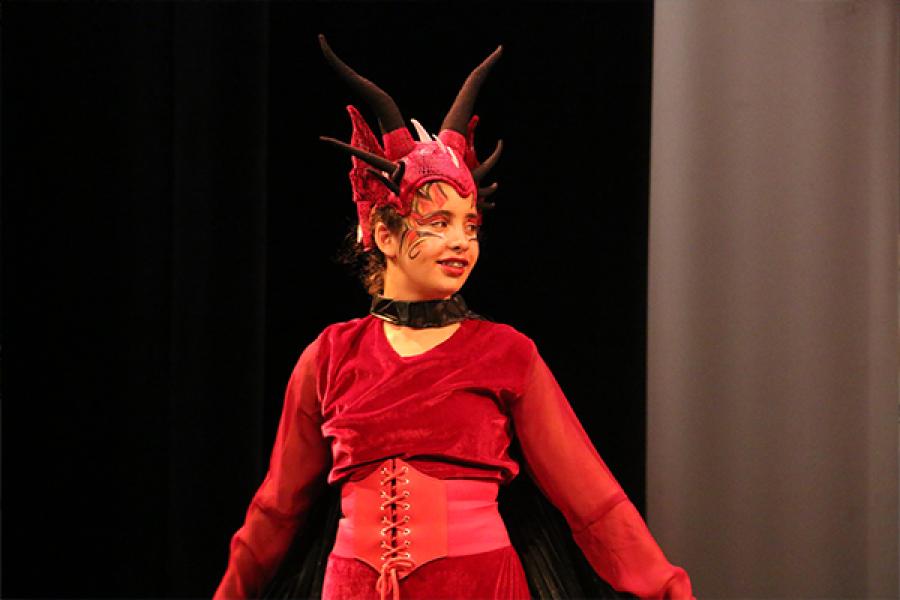 Child in costume on stage during camp performance