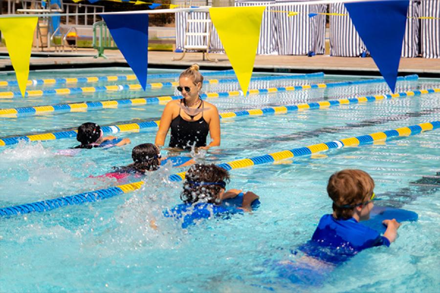 Children and swim instructor in pool