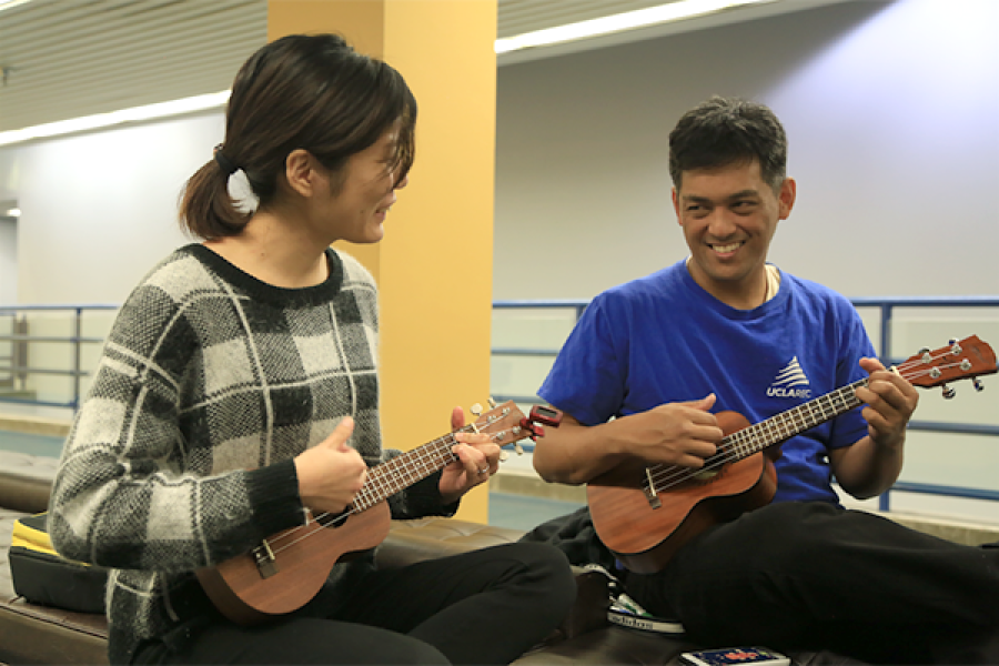 Two students playing Guitars