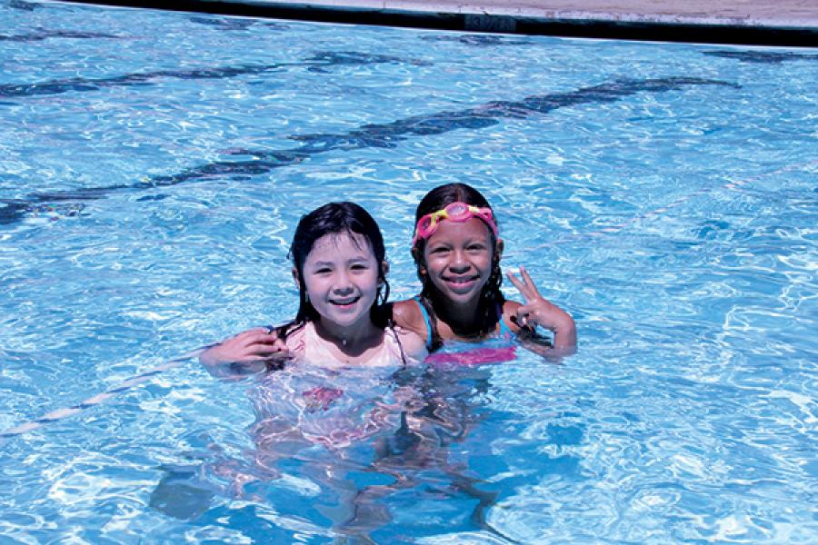 two children swimming in the pool