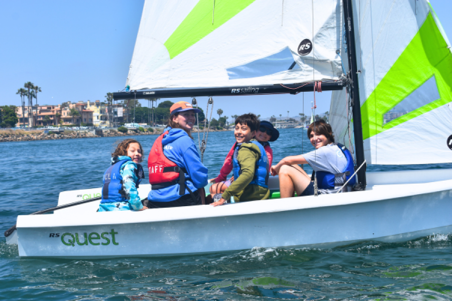 group of kids and counselor on sail boat